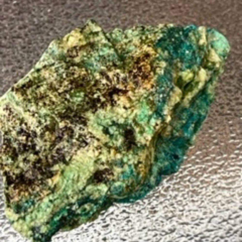 A Raw Turquoise / Chrysocolla stone hand minded in Tucson with layered shades